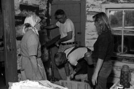 Bill Morgan and students plaster walls in a home, St. Cloud State University