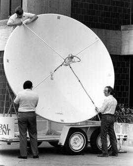 Doug Moilanen, Craig Muhr, and Rich Josephson waits for a satellite dish to be installed, St. Cloud State University