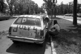 Two women decorate a car in honor of the bicentennial, St. Cloud State University