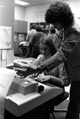 Psychology students look at computer printout, St. Cloud State University