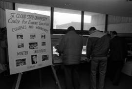 Attendees browse material at the Winter Institute, St. Cloud State University