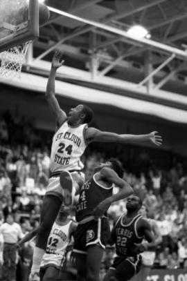 Basketball player Reggie Perkins makes a lay up during a game against Ferris State University, St. Cloud State University