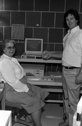 Keith Ewing and Virginia Blaske use a computer in the library, St. Cloud State University