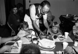 James Gammell serves food to children, St. Cloud State University