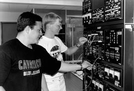 Two students check equipment, St. Cloud State University