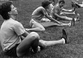 Men's cross country team members stretch, St. Cloud State University