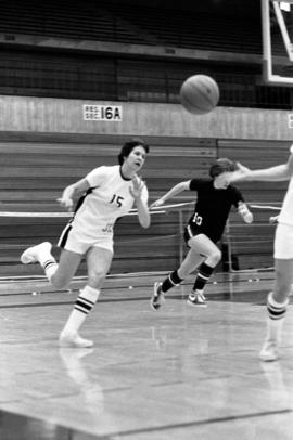 Basketball player Sue Wahl passes a ball during a basketball against Winona State University at Halenbeck Hall (1965)