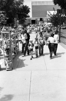 People walk past art vendors, Lemonade Concert and Art Fair, St. Cloud State University