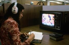 Woman watches a video at Centennial Hall (1971), St. Cloud State University