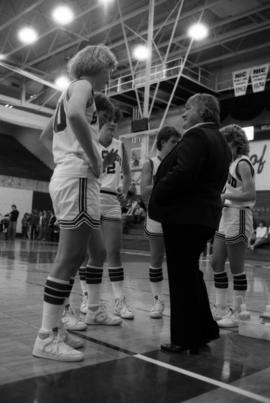 Basketball coach Gladys Ziemer talks to her players