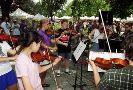 A group plays violins together, Lemonade Concert and Art Fair, St. Cloud State University