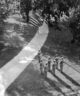 Soldiers from the Air Corps' 72nd Detachment lower the flag, St. Cloud State University