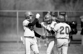 Baseball player Pete Pratt congratulates a teammate during a baseball game, St. Cloud State University