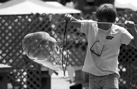 A man creates giant bubbles, Lemonade Concert and Art Fair, St. Cloud State University