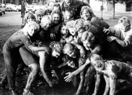 Men and women after a mud football game, St. Cloud State University