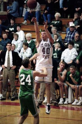 Jason Kron shoots a basketball during a basketball game against the University of North Dakota