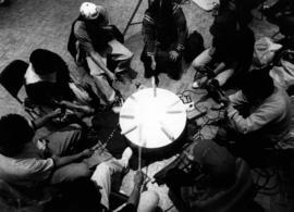 Men play drums at a pow wow, St. Cloud State University