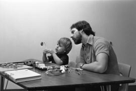 A man works with a child, Speech Pathology, St. Cloud State University