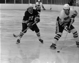 St. Cloud State hockey player Pat Sullivan handles the puck against Hamline University in men's hockey