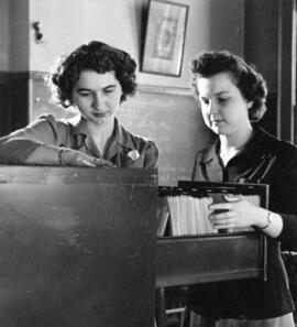 Rosemary Gabriel and Betty Benson look through a file cabinet, St. Cloud State University