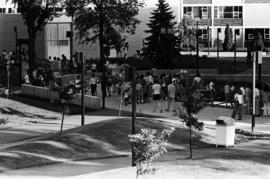 People gather on sidewalks to visit vendors' booths, Lemonade Concert and Art Fair, St. Cloud State University