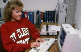 Woman uses a computer at Centennial Hall (1971), St. Cloud State University