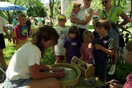 Children watch a person create pottery, Lemonade Concert and Art Fair, St. Cloud State University