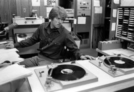 A KVSC disc jockey plays records, St. Cloud State University