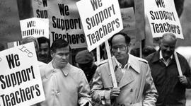 Fran Voekler and Howard Mathias walk with striking teachers from District 742