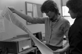 Women look at a document, St. Cloud State University