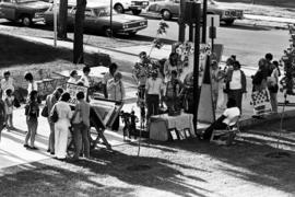 People gather on sidewalks to visit vendors' booths, Lemonade Concert and Art Fair, St. Cloud State University