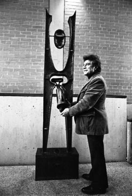 Artist Tony Caponi with his metal sculpture in Atwood Memorial Center (1966) entitled Cathedral, St. Cloud State University