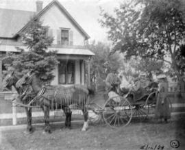 E.J. and Isabel Lewis with son Fred Lewis in front of Lewis home in Sauk Centre, Minnesota