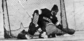 A hockey goalie makes a stop during a hockey game, St. Cloud State University