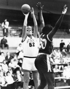 St. Cloud State University basketball player shoots for a basket