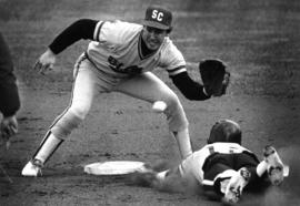 Baseball player catches a ball above a sliding player, St. Cloud State University