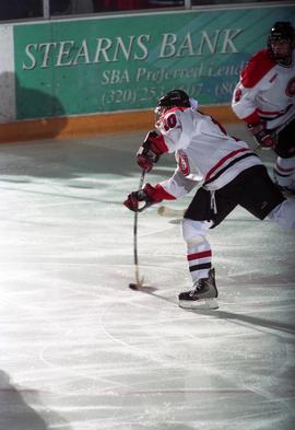 St. Cloud State University hockey player takes a shot during a hockey game against the University of Wisconsin