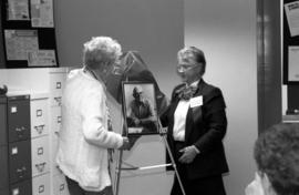 A portrait of Paul Swensson is unveiled at the dedication of a room in Stewart Hall (1948) in the Mass Communications department, St. Cloud State University