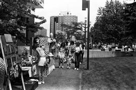 People gather on sidewalks to visit vendors' booths, Lemonade Concert and Art Fair, St. Cloud State University