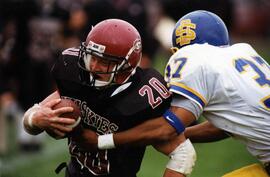 Randy Martin runs with a football during a game, St. Cloud State University