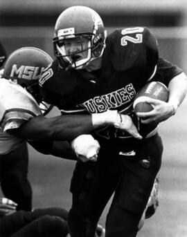 Randy Martin runs with a football during a game, St. Cloud State University