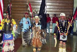 Pow wow participants carry flags, St. Cloud State University