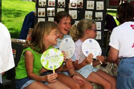 Three girls sit together, Lemonade Concert and Art Fair, St. Cloud State University
