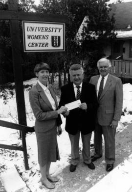 Jane Olsen, Millard Smith and David Sprague stand together in front of the Women's Center, St. Cloud State University