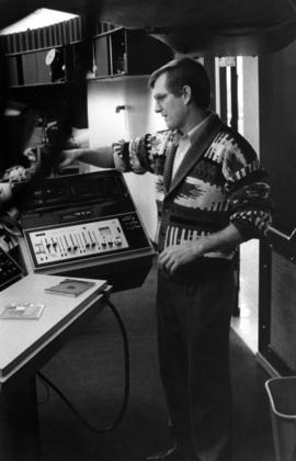 John Peck operates the planetarium equipment, Mathematics and Science Center (1973), St. Cloud State University