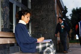 Woman studies in front of Mitchell Hall (1958), St. Cloud State University