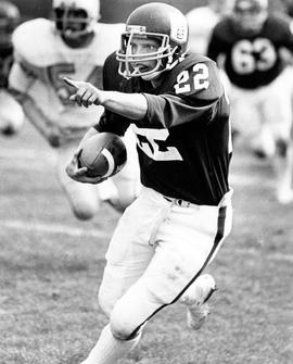 A football player runs during a game against Mankato State University, St. Cloud State University