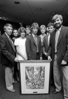 Former Atwood Memorial Center director Joe Basil accepts a painting from the family of Janelle Johnson, St. Cloud State University