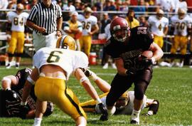 Randy Martin runs with a football during a game, St. Cloud State University