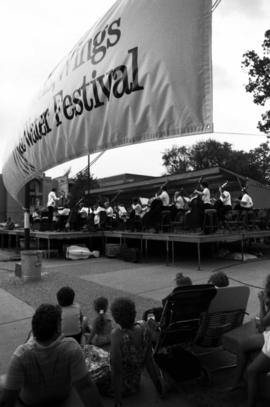 People watch an orchestra perform on a stage, Lemonade Concert and Art Fair, St. Cloud State University